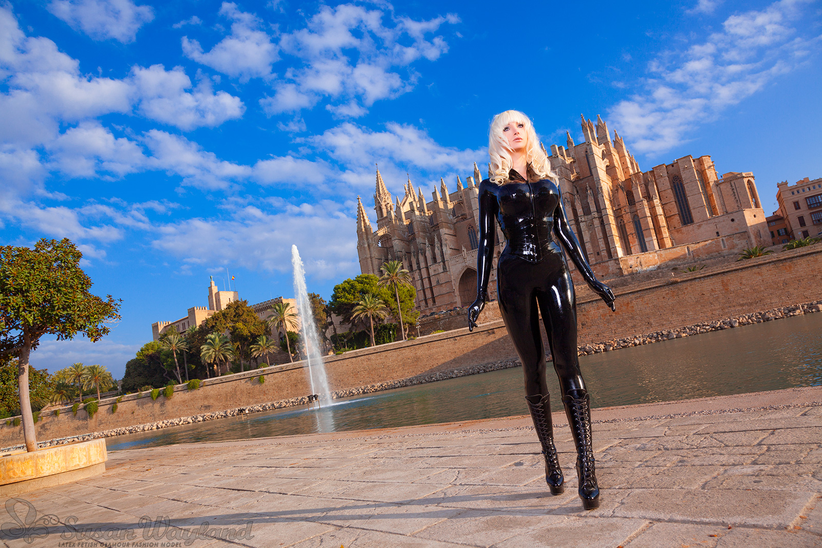 blonde_hair boots breasts catsuit female high_heels large_breasts latex long_hair nose_piercing outside piercing solo susan_wayland watermark