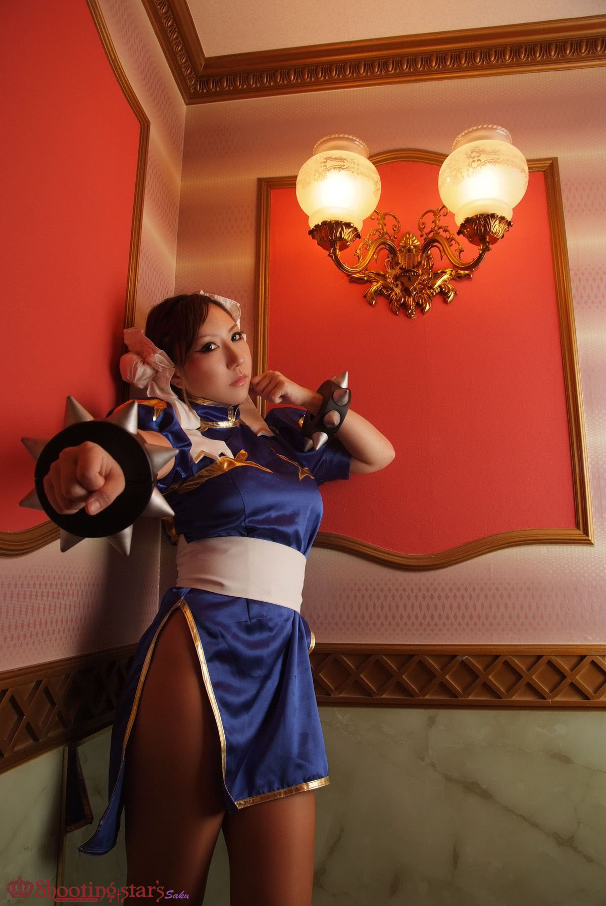 1girl asian breasts brown_hair capcom chun-li clothed cosplay female female_only long_hair looking_at_viewer non-nude posing shooting_star solo street_fighter watermark