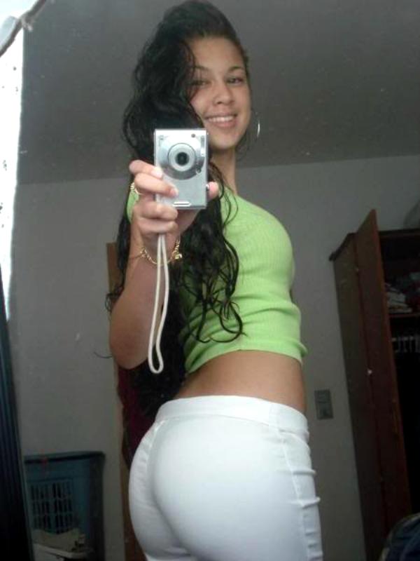 ass backside black_hair earrings latina long_hair looking_back midriff self_shot smile yoga_pants