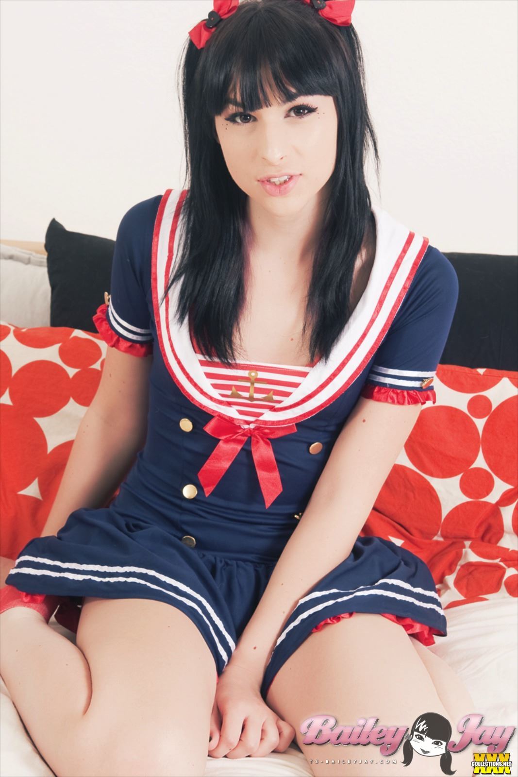 bailey_jay black_hair bow clothed cute long_hair looking_at_viewer non-nude on_knees parted_lips porn_star sailor_uniform shemale solo transgender watermark