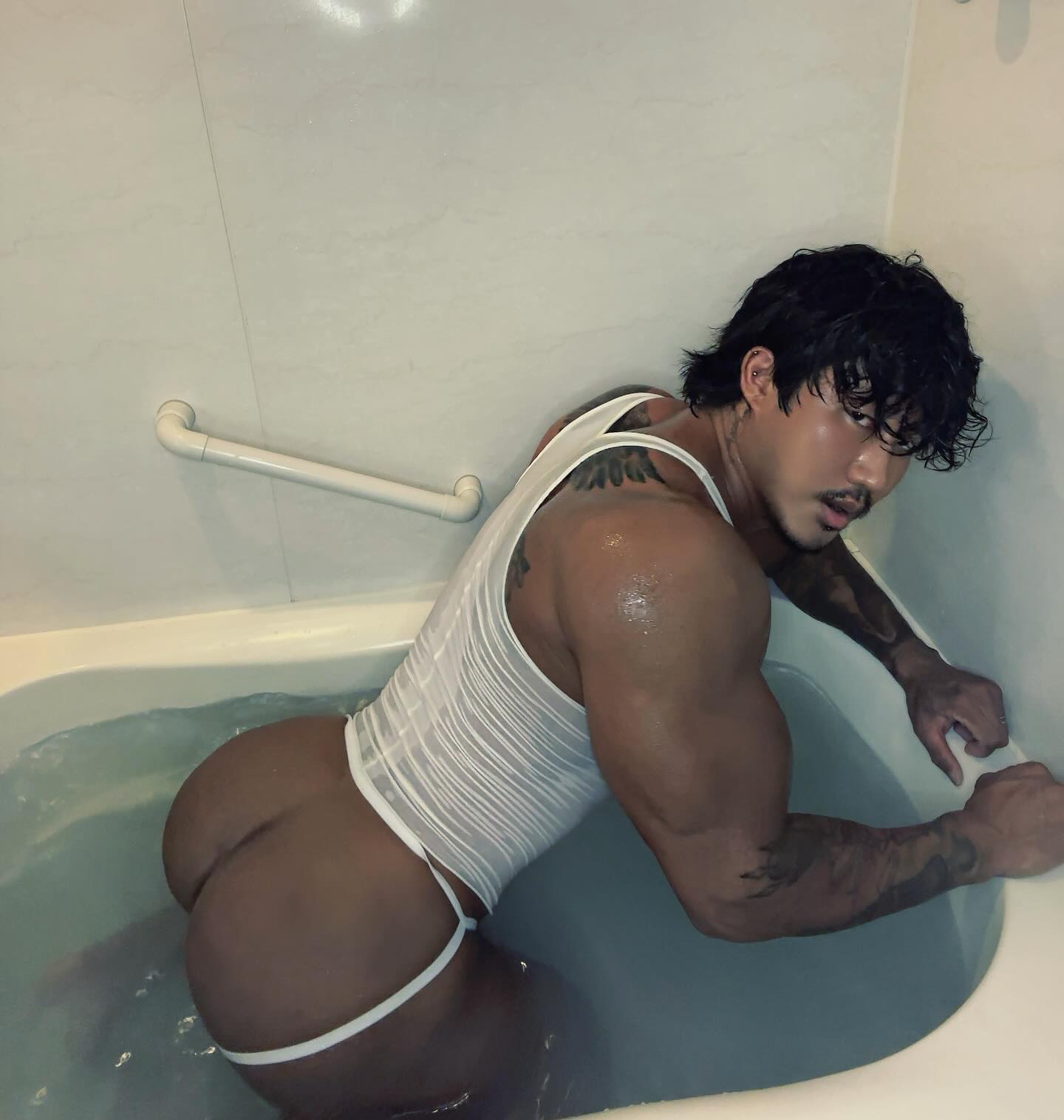 1boy asian asian_male ass bathtub black_hair chinese gay instagram jockstrap leo_lee looking_at_viewer male male_focus male_only masculine muscular_male non-nude solo solo_male sourced tattoo wet wet_body wet_hair wet_skin