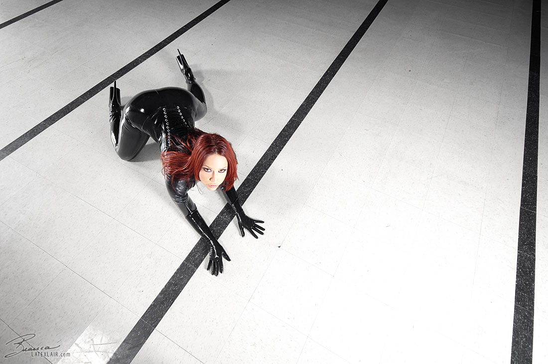 bianca_beauchamp breasts catsuit female gloves high_heels large_breasts latex long_hair red_hair shoes solo watermark