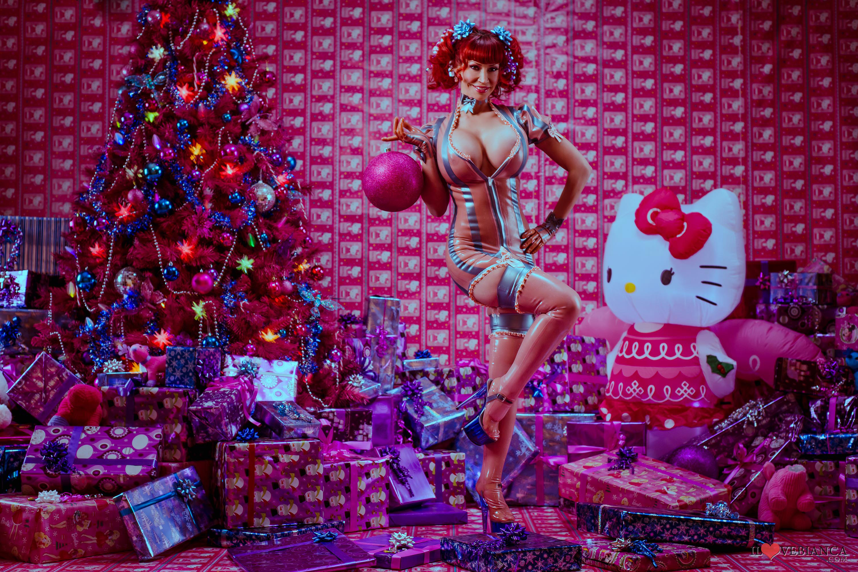 1girl bianca_beauchamp christmas_tree cleavage clothed dress female female_only hand_on_hip hello_kitty high_heels large_breasts leg_up long_hair looking_at_viewer non-nude pigtails posing red_hair smile solo stockings tan_skin thighhighs tight_fit watermark