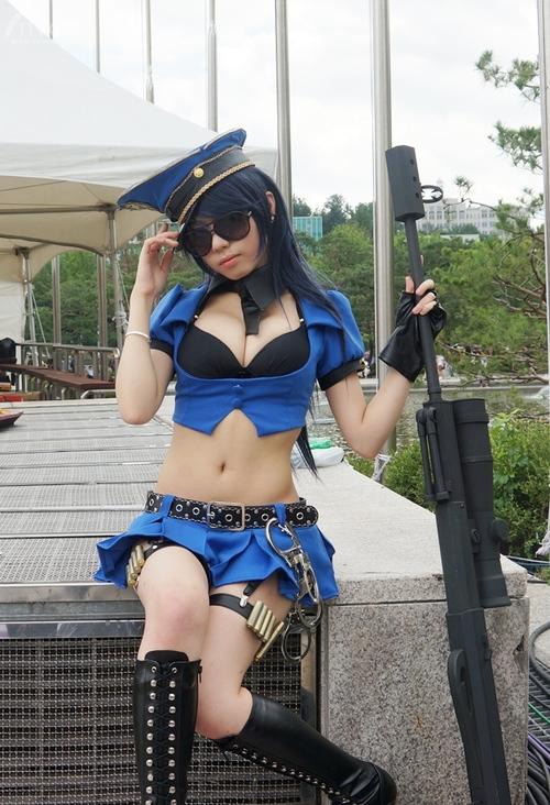 1girl caitlyn_(league_of_legends) cleavage cosplay gun league_of_legends outside sitting solo sunglasses