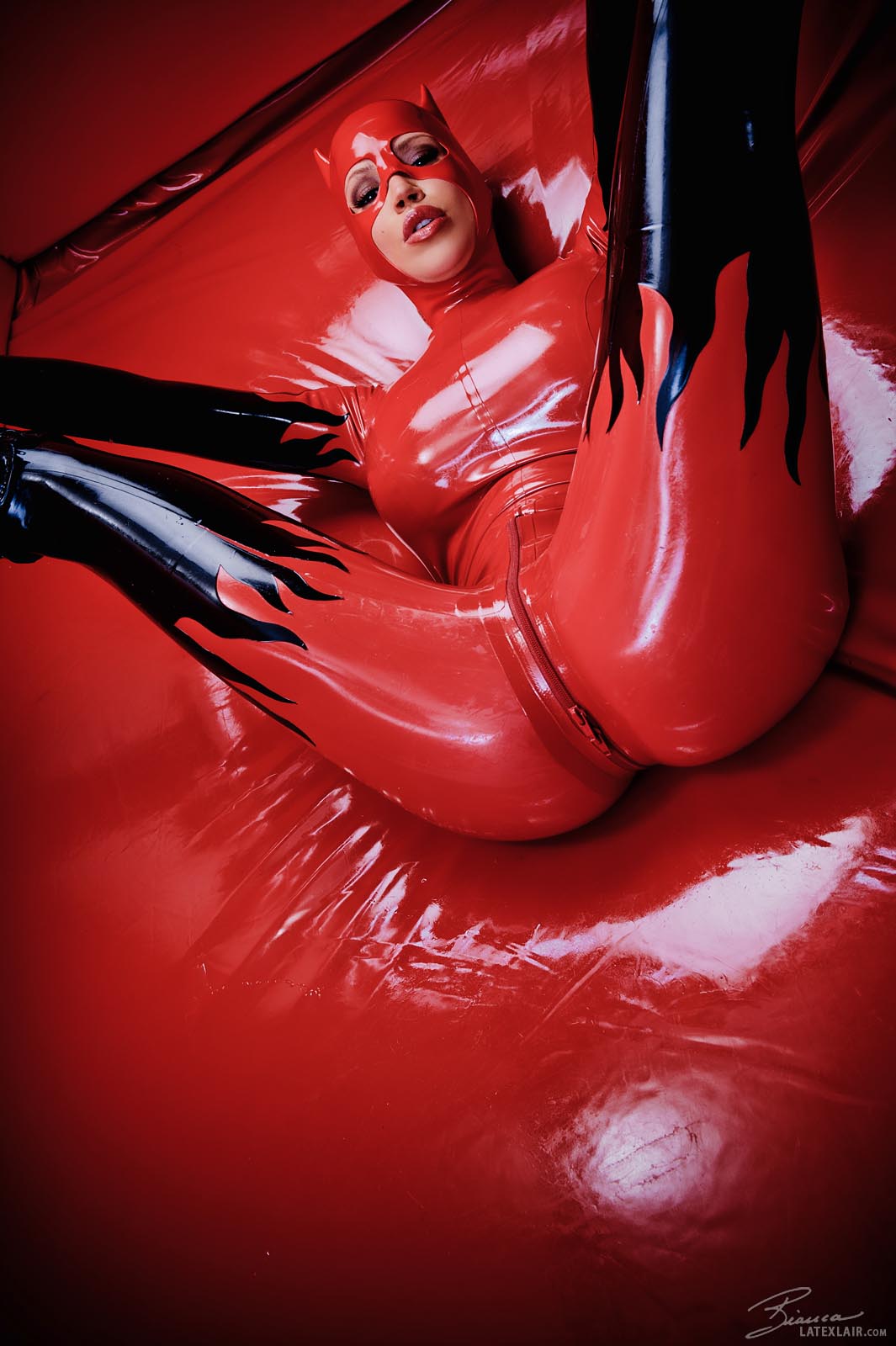 bianca_beauchamp breasts catsuit female gloves large_breasts latex long_hair mask red_hair simple_background solo watermark