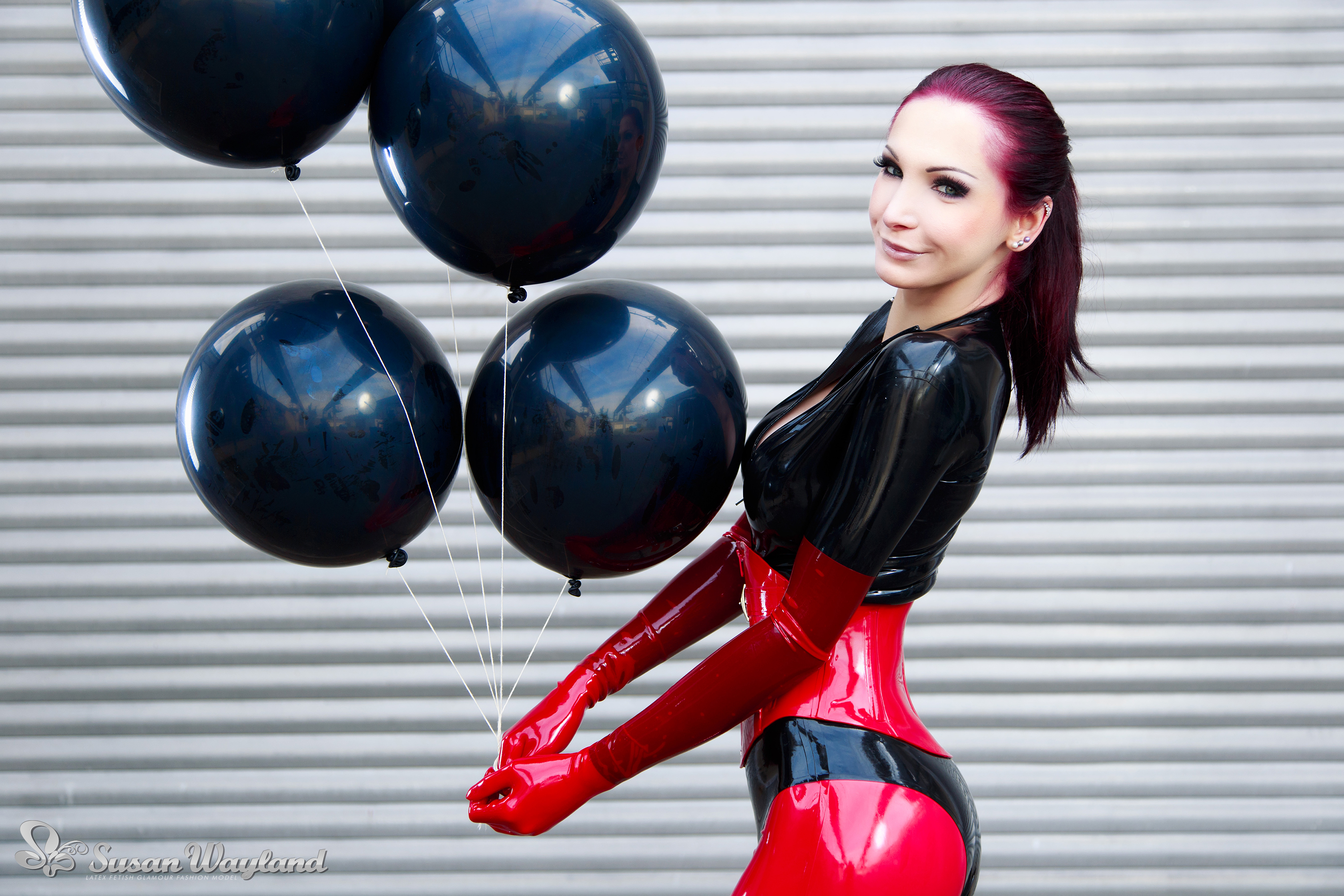 balloon black_hair breasts catsuit corset female gloves high_heels large_breasts latex long_hair shoes solo susan_wayland watermark