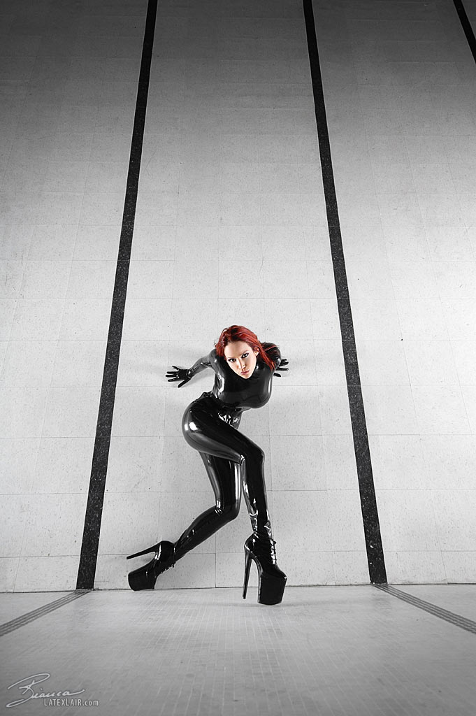 bianca_beauchamp breasts catsuit female gloves high_heels large_breasts latex long_hair red_hair shoes solo watermark