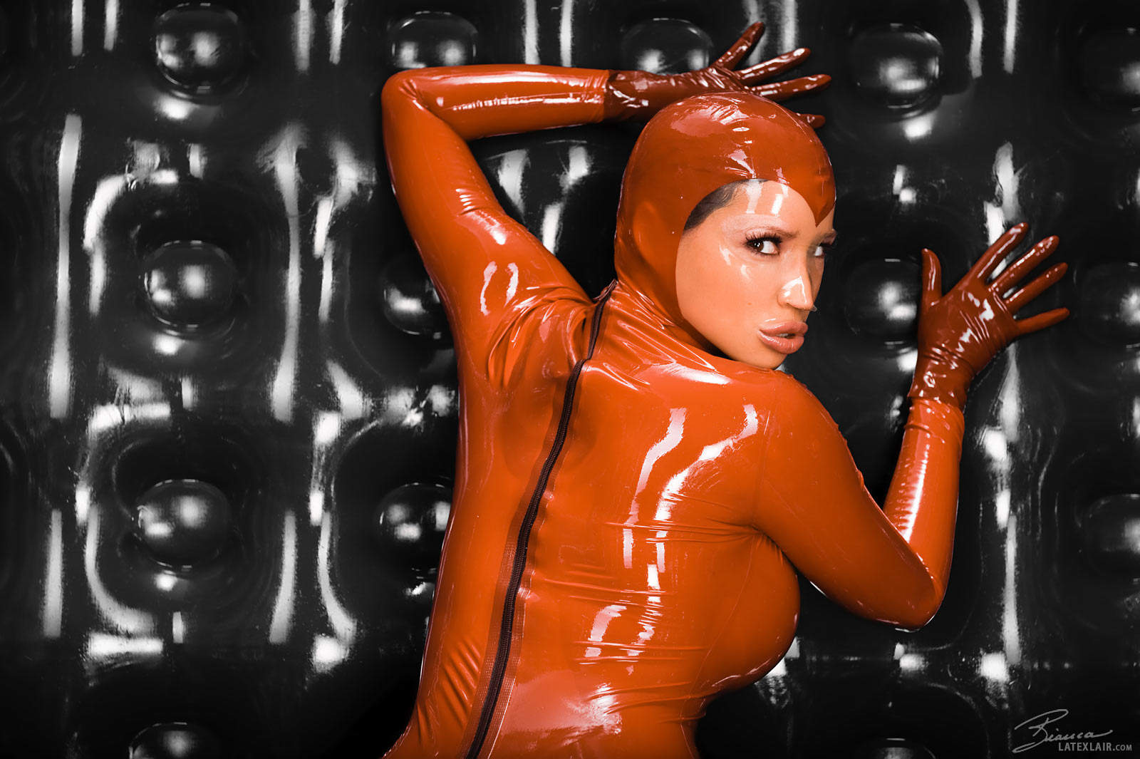 bianca_beauchamp breasts catsuit female gloves large_breasts latex long_hair red_hair solo watermark