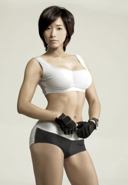 1girl abs asian breasts brown_eyes brown_hair cleavage fingerless_gloves gloves gym_clothes gym_shorts looking_at_viewer midriff muscle navel photo short_hair short_shorts shorts solo sports_bra sports_shorts sports_wear standing