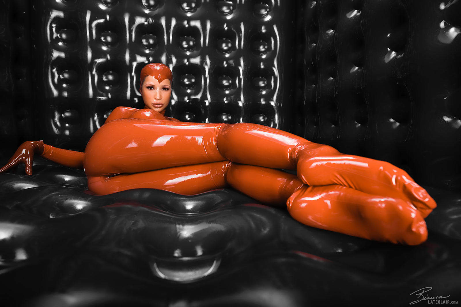 ass bianca_beauchamp breasts catsuit female gloves large_breasts latex long_hair looking_back red_hair solo watermark