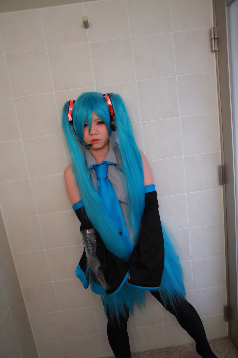 asian blue_hair breasts cosplay female headphones long_hair necktie skirt solo thighhighs