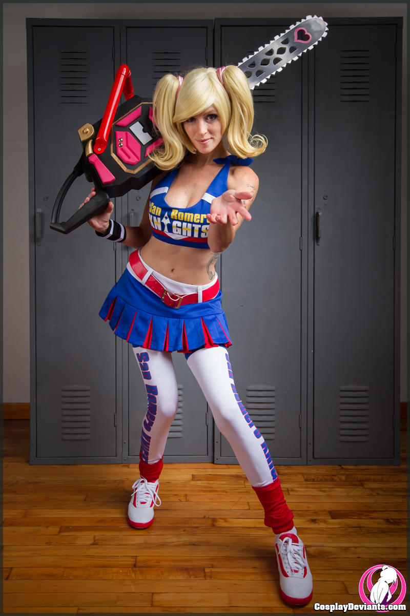 blonde_hair breasts chainsaw cosplay cosplaydeviants female juliet_starling kneehighs large_breasts lolita_zombie lollipop_chainsaw long_hair pigtails shoes solo watermark weapon