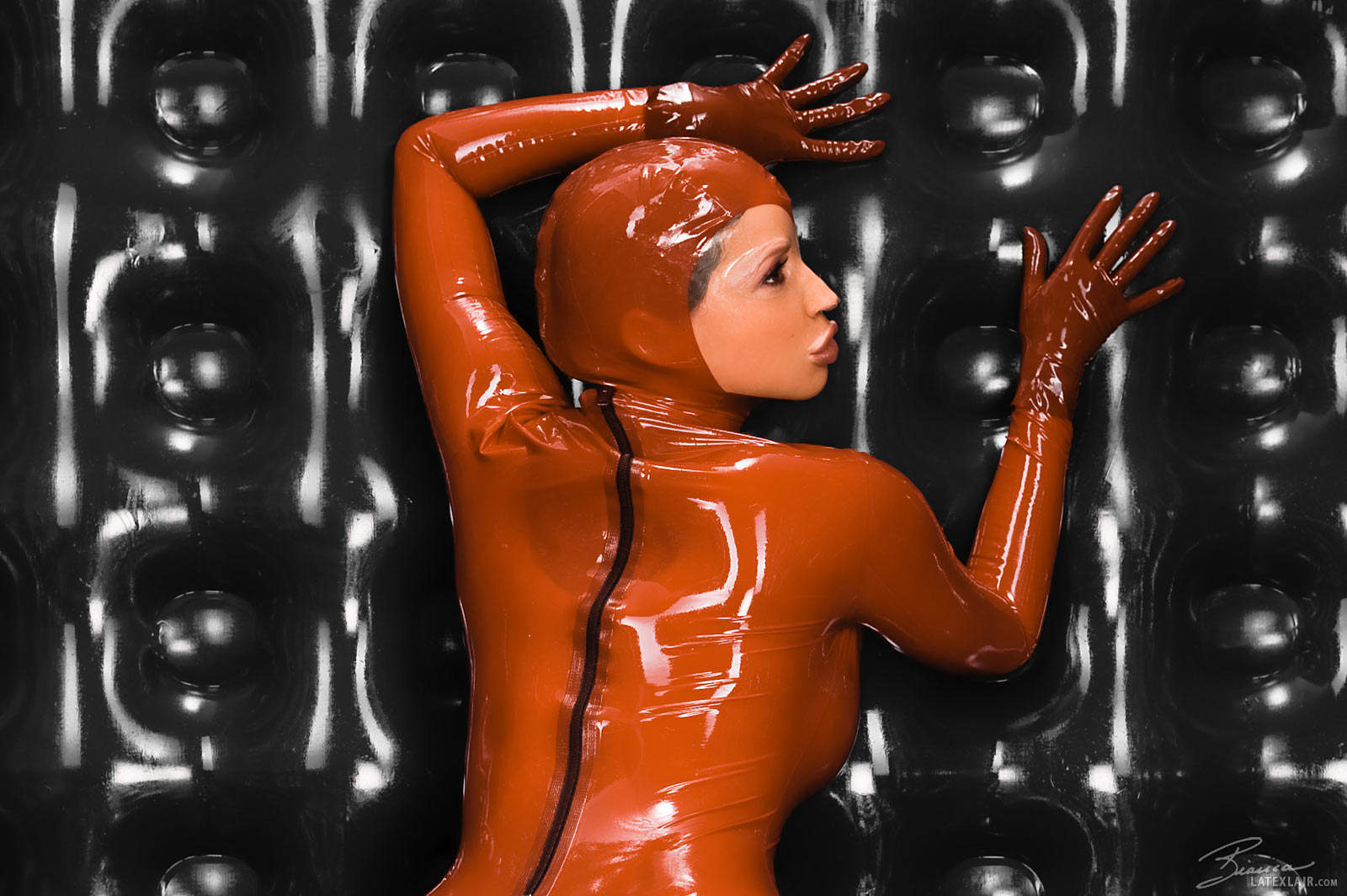 bianca_beauchamp breasts catsuit female gloves large_breasts latex long_hair red_hair solo watermark