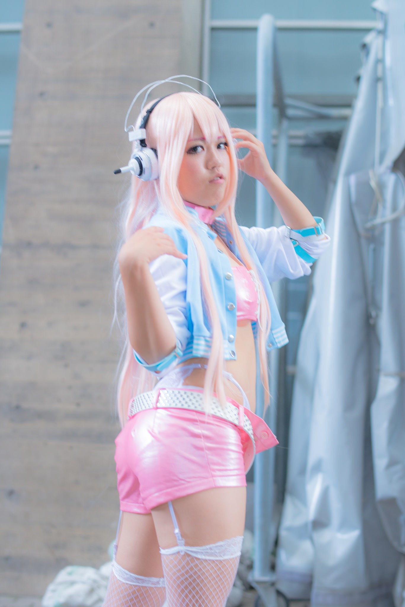 asian ass breasts cleavage collar cosplay female fishnets headphones large_breasts long_hair looking_back midriff navel pink_hair solo