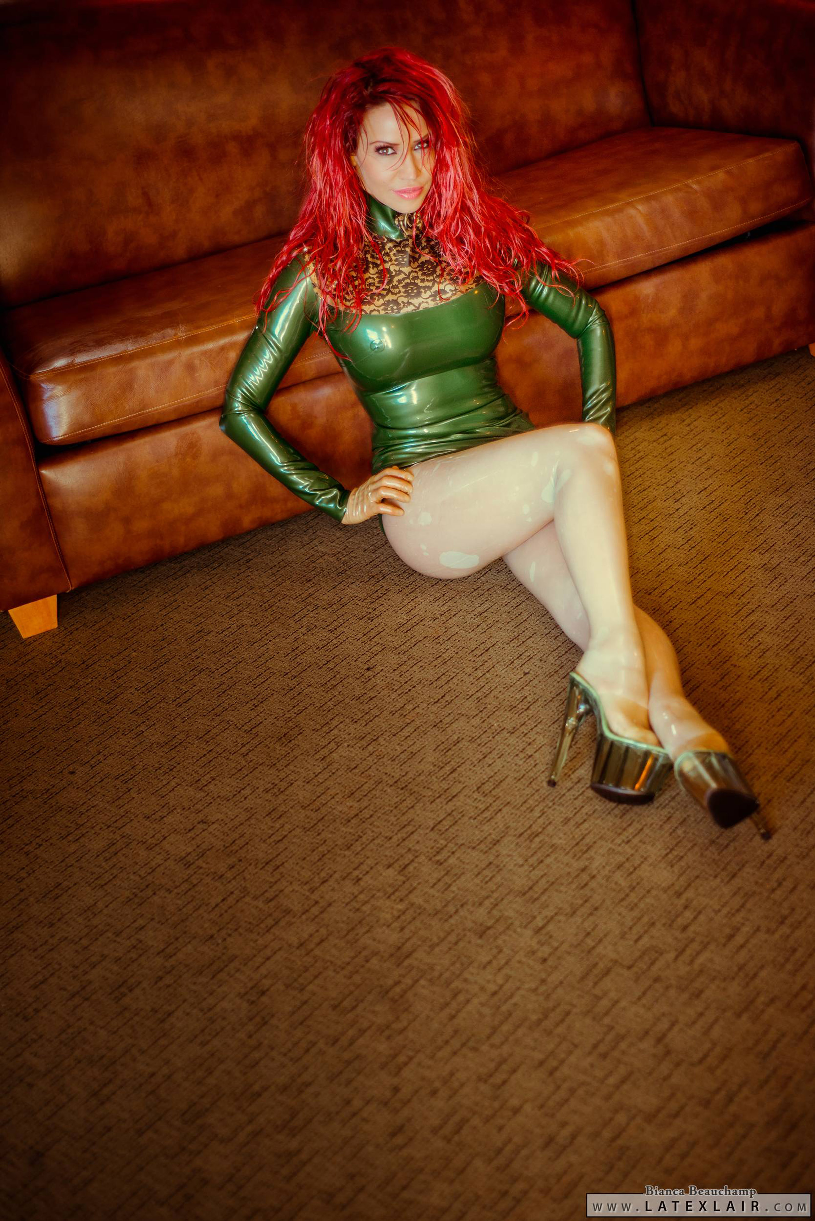 bianca_beauchamp breasts dress female high_heels large_breasts latex long_hair red_hair shoes sofa solo watermark