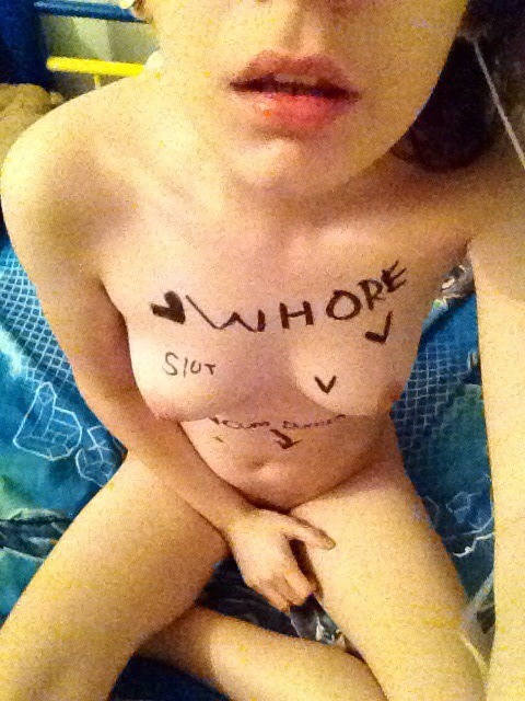 1girl body_writing covering_pussy female female_only nude self_shot sitting slut.rus_(user) small_breasts solo solo_female