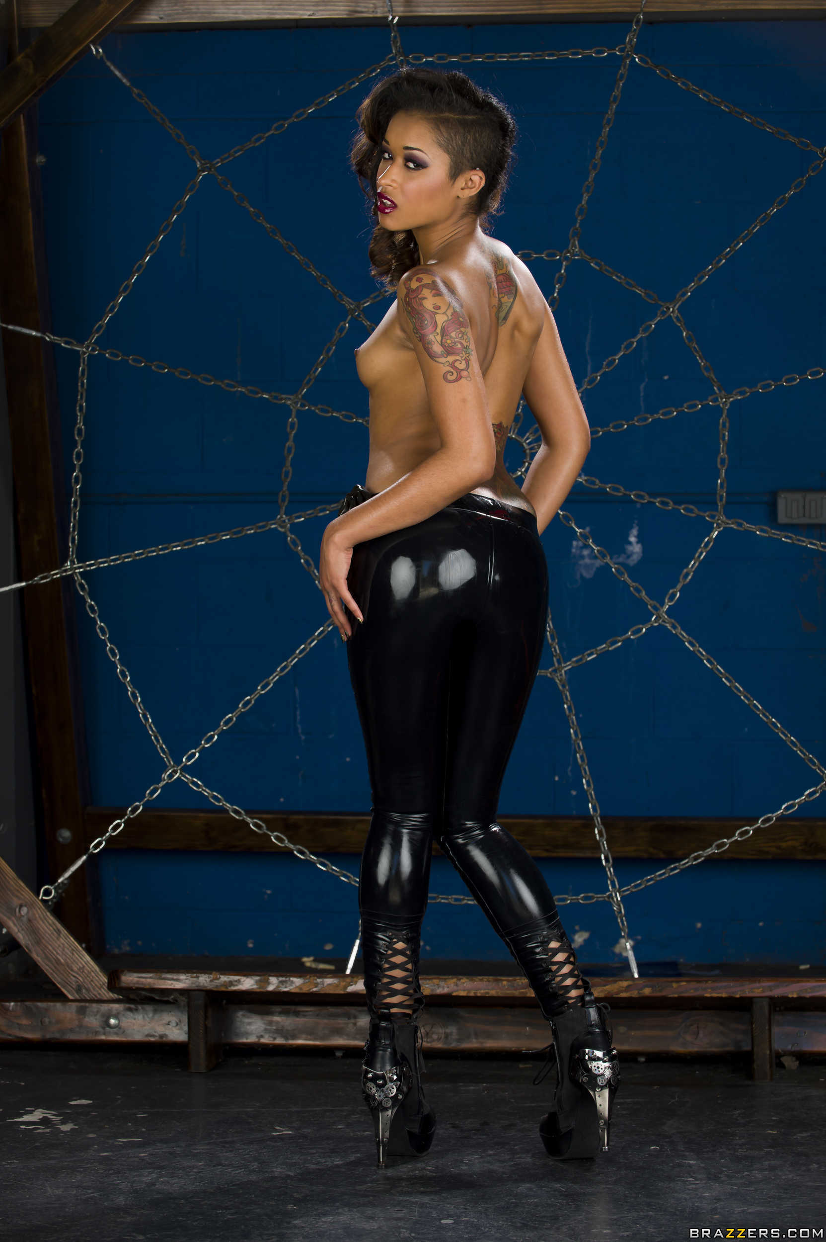 breasts brown_hair female high_heels latex lipstick long_hair navel navel_piercing nose_piercing piercing shoes skin_diamond solo