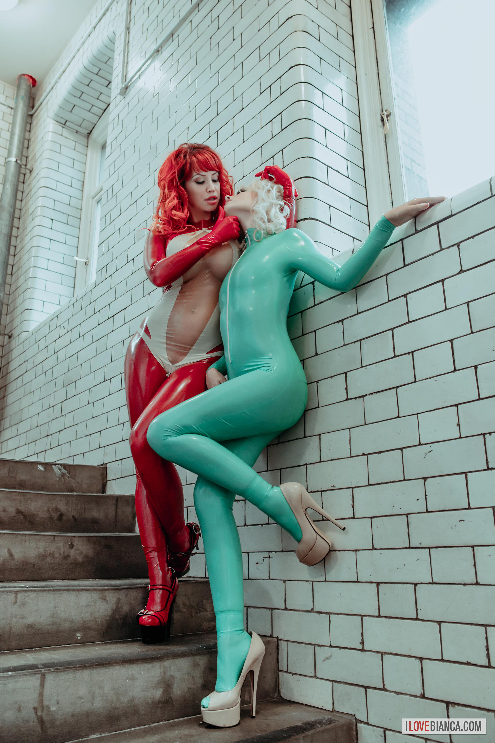 bianca_beauchamp breasts catsuit female gloves high_heels large_breasts latex long_hair red_hair shoes solo watermark