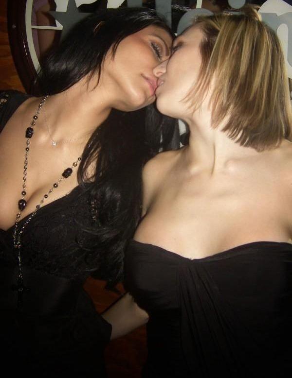 2girls bare_shoulders black_dress black_hair blonde blonde_hair breasts cleavage closed_eyes dress eyeshadow female female_only hair incipient_kiss jewelry kissing lesbian lips long_hair makeup multiple_girls neck necklace photo real_person short_hair smile strapless strapless_dress