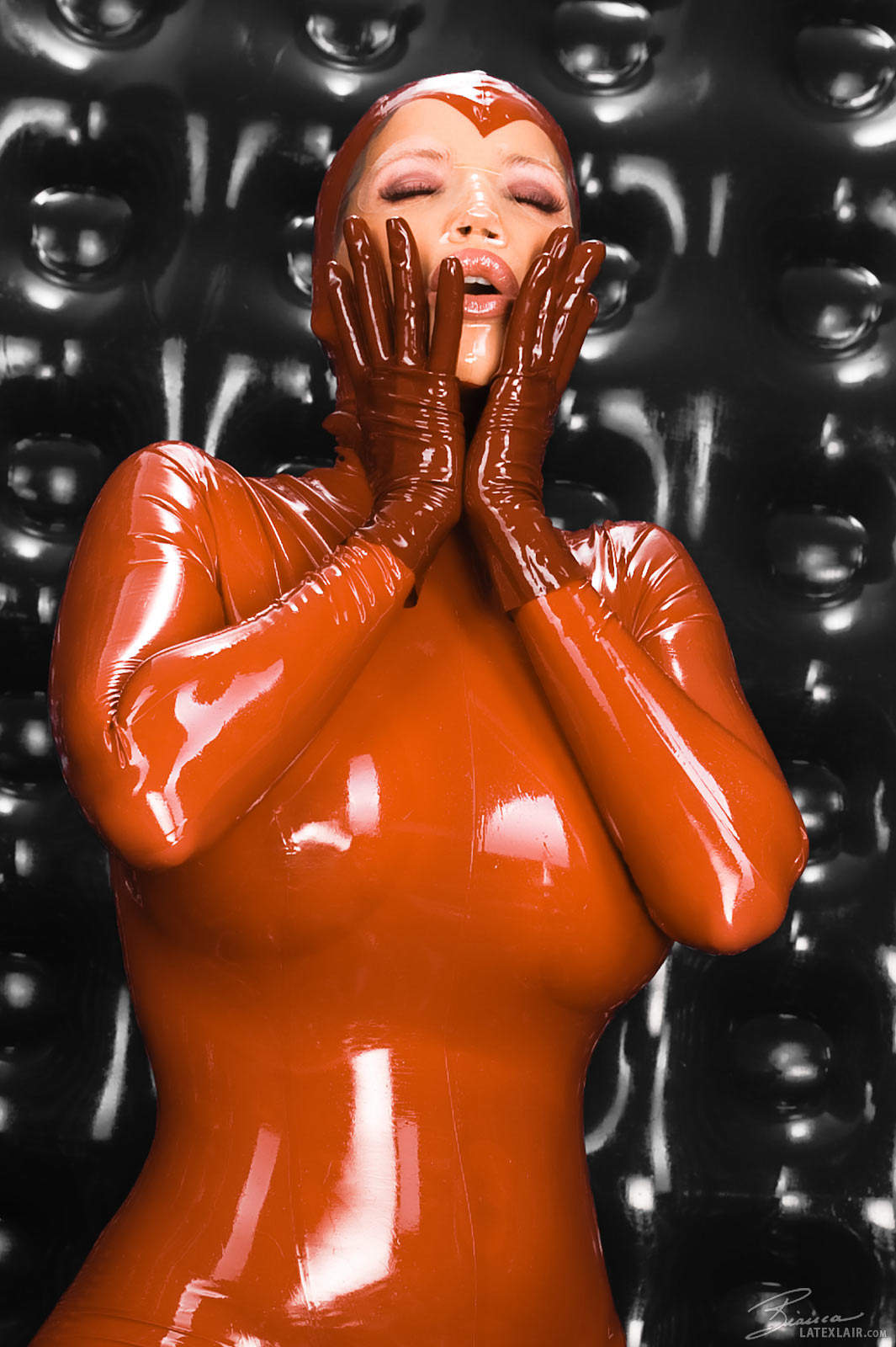 bianca_beauchamp breasts catsuit female gloves large_breasts latex long_hair red_hair solo watermark