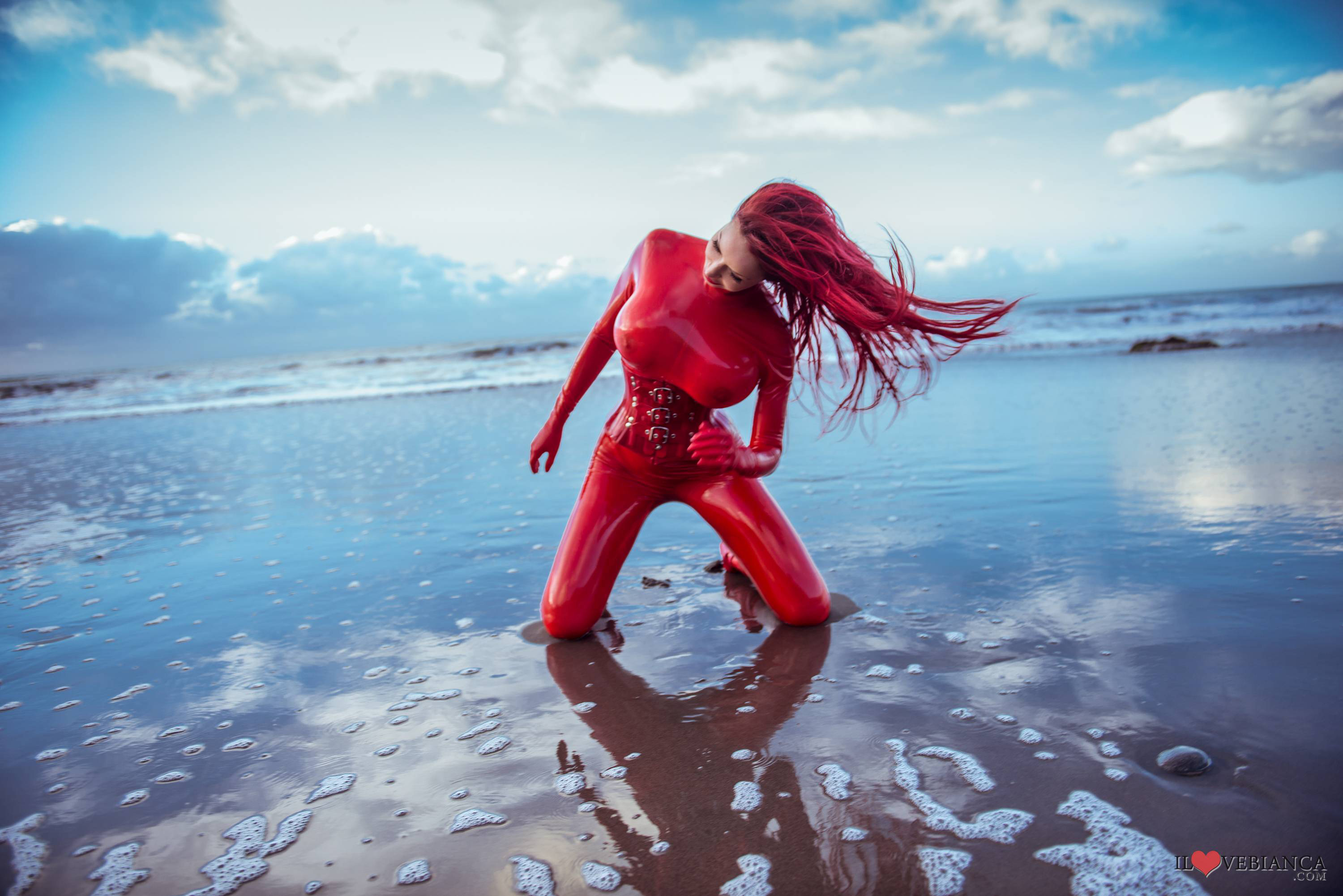 beach bianca_beauchamp breasts catsuit female gloves large_breasts latex long_hair outside red_hair solo water watermark