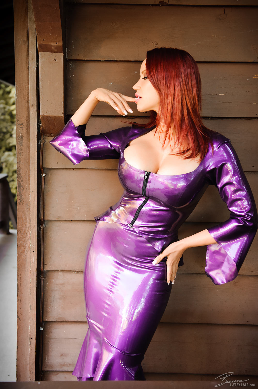 bianca_beauchamp breasts cleavage dress female large_breasts latex long_hair outside red_hair solo watermark