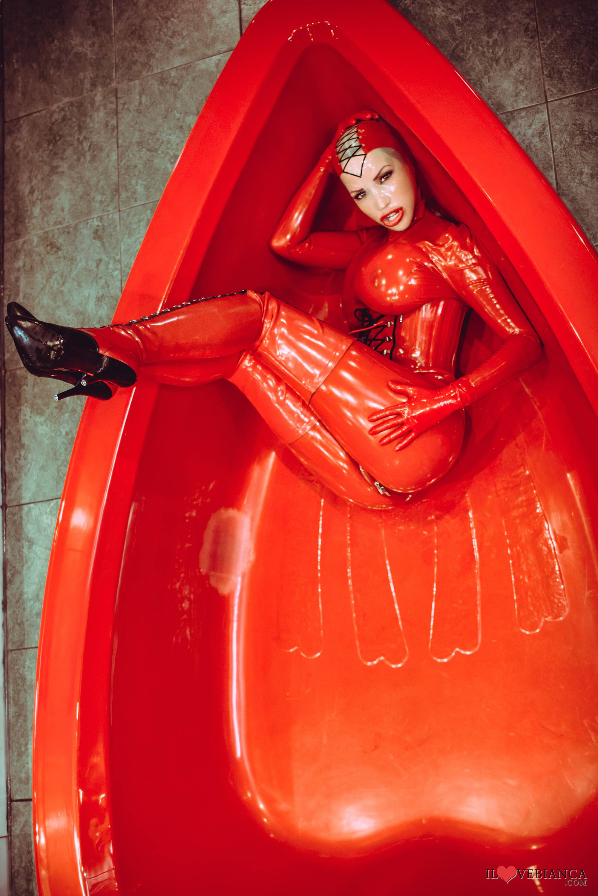 bianca_beauchamp breasts catsuit corset female large_breasts latex long_hair mask red_hair solo watermark