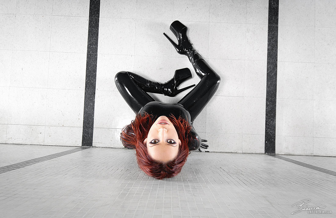 bianca_beauchamp breasts catsuit female gloves high_heels large_breasts latex long_hair red_hair shoes solo watermark