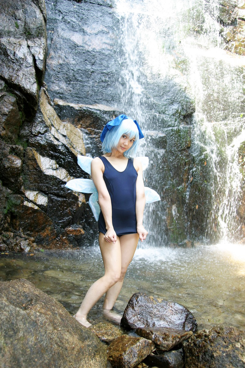 1girl aqua_hair asian barefoot breasts cirno cosplay female japanese lenfried long_hair one-piece_swimsuit outside ribbon school_swimsuit solo sukumizu swimsuit touhou water waterfall watermark wet wings