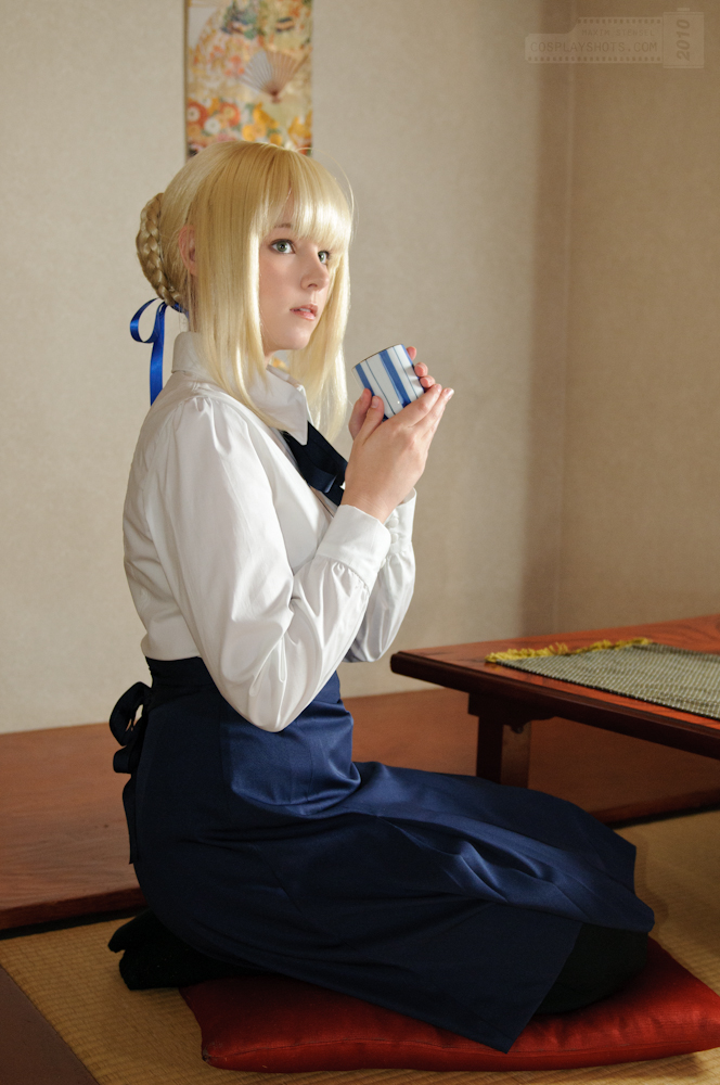 1girl asian blonde_hair breasts cosplay fate/stay_night fate_(series) female long_hair saber sitting solo