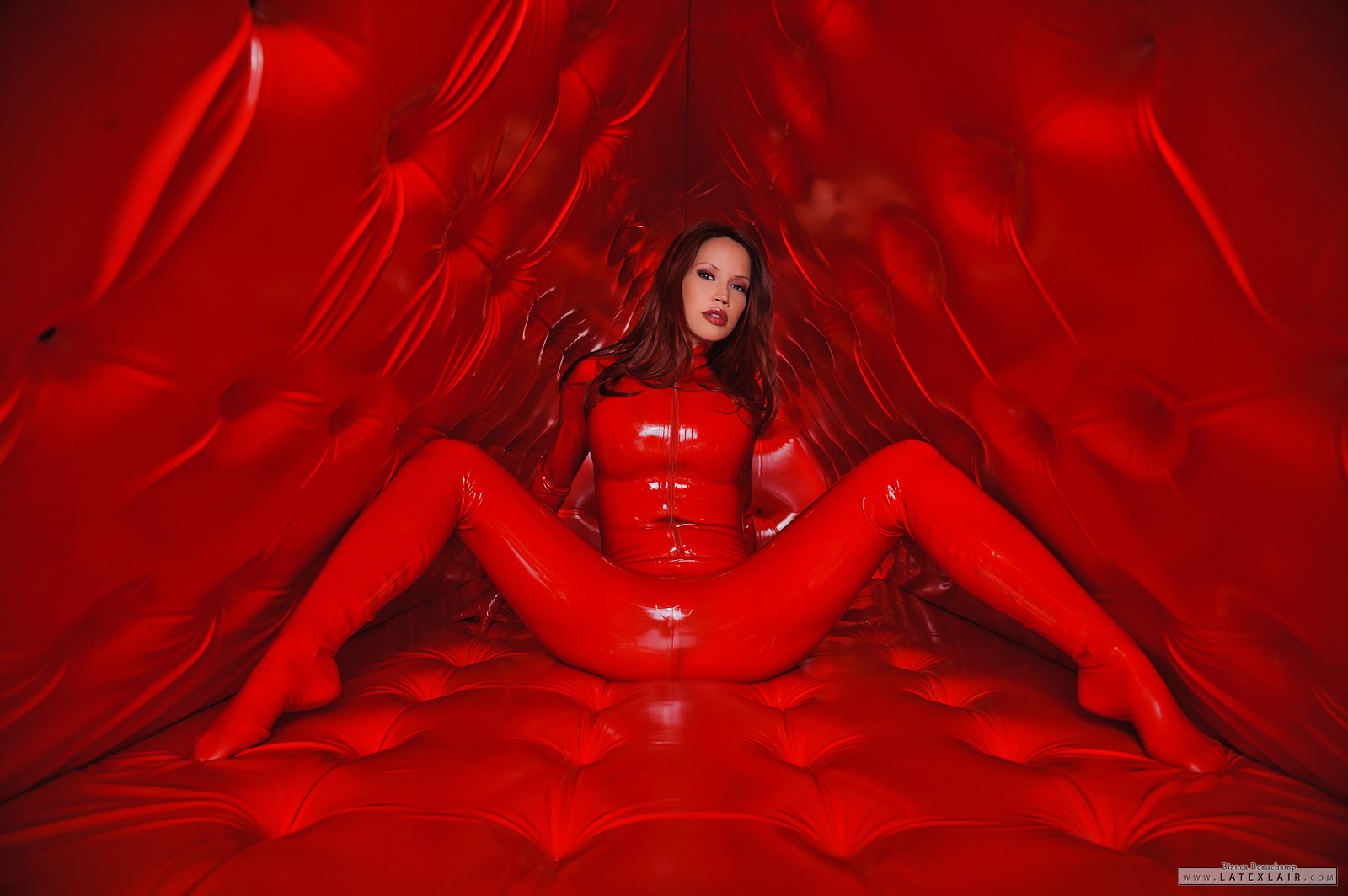 bianca_beauchamp breasts catsuit female gloves high_heels large_breasts latex long_hair red_hair shoes simple_background solo watermark