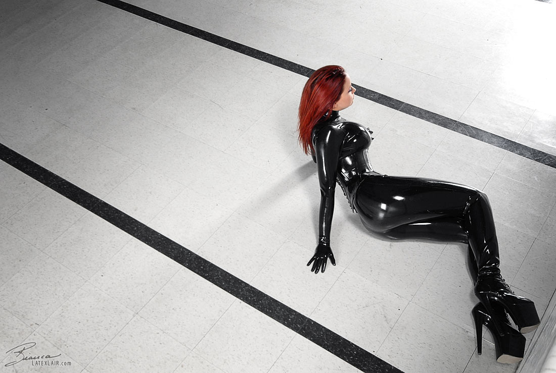 bianca_beauchamp breasts catsuit female gloves high_heels large_breasts latex long_hair red_hair shoes solo watermark