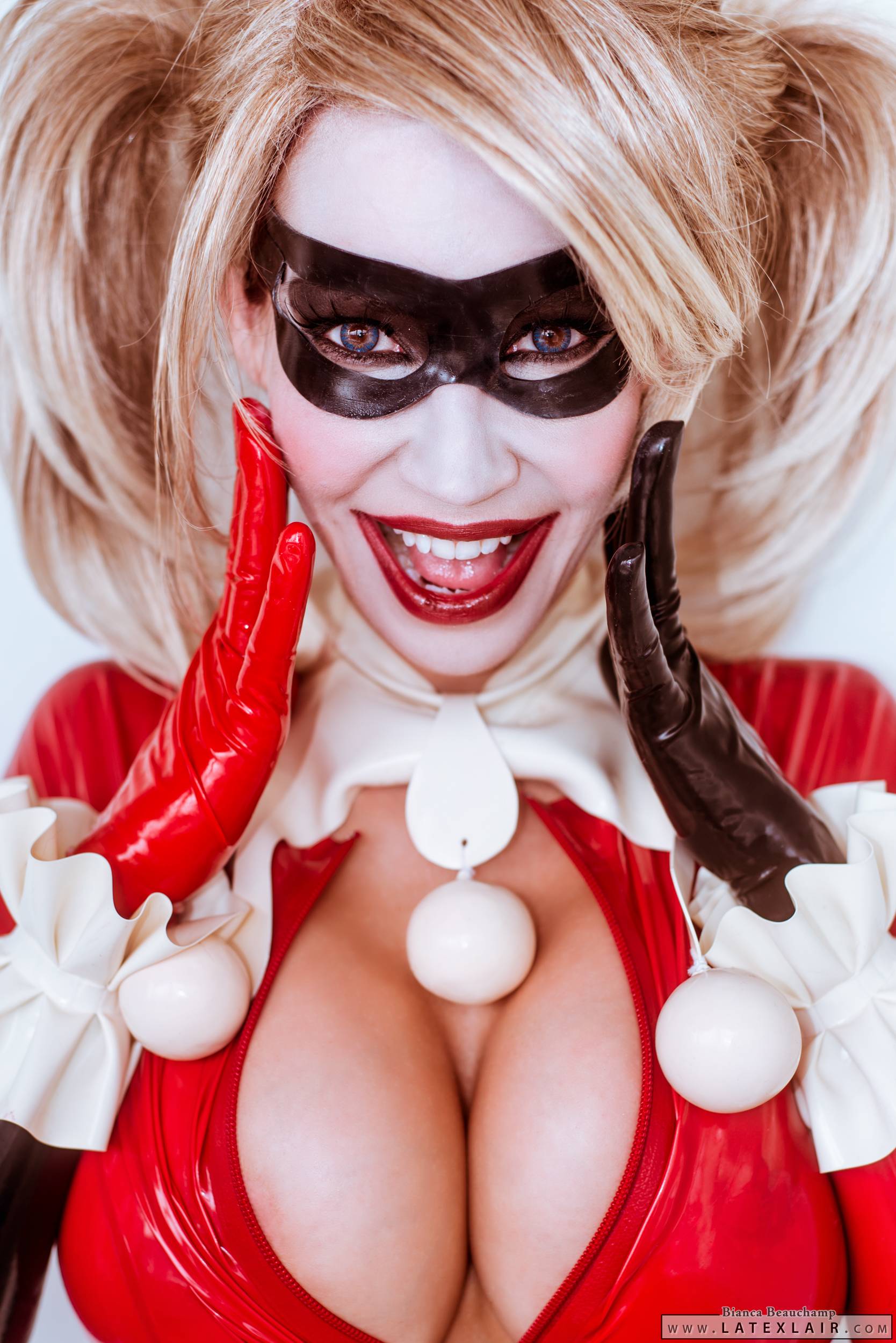 bianca_beauchamp blonde_hair breasts cleavage female gloves large_breasts latex lipstick long_hair mask open_mouth smile solo