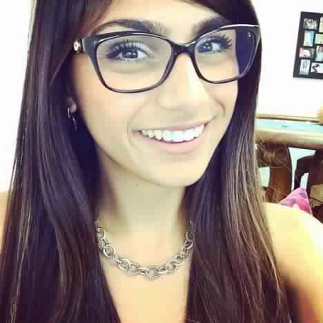 brown_eyes brown_hair female glasses lebanese_american mia_khalifa smile tan_skin