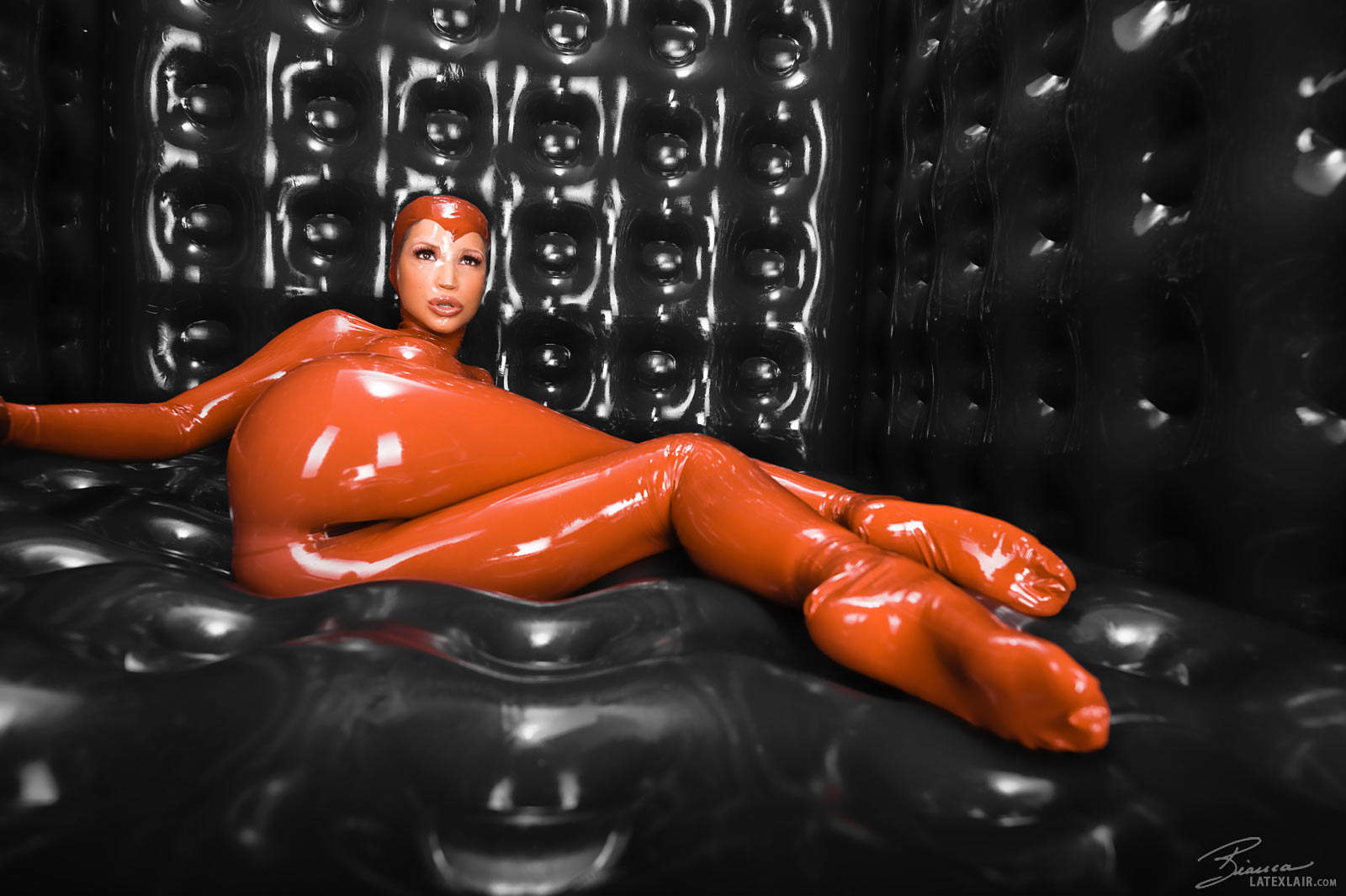 ass bianca_beauchamp breasts catsuit female gloves large_breasts latex long_hair looking_back red_hair solo watermark