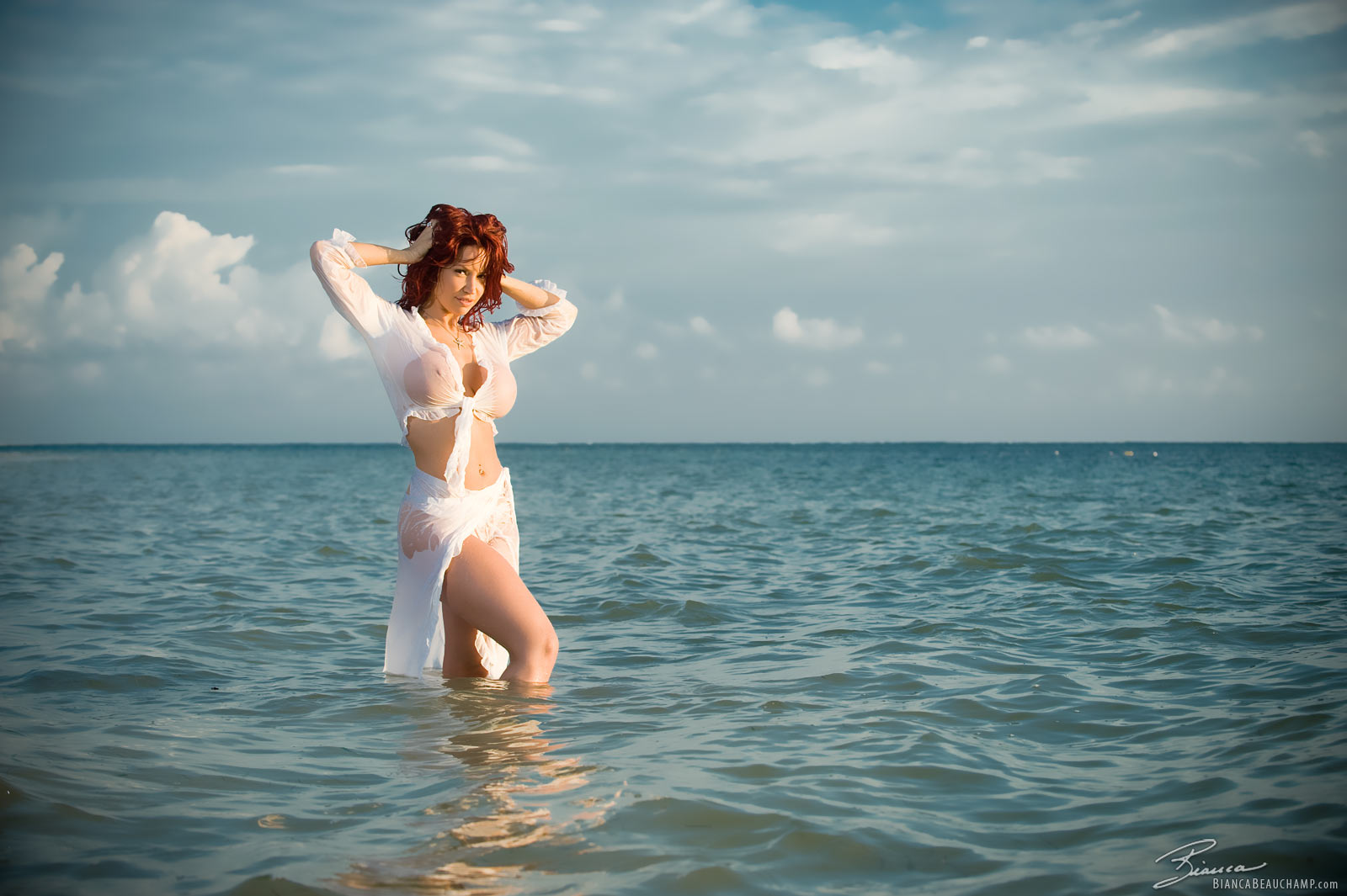 arms_up beach bianca_beauchamp breasts female large_breasts long_hair midriff navel navel_piercing outside piercing red_hair see-through smile solo water watermark wet wet_clothes