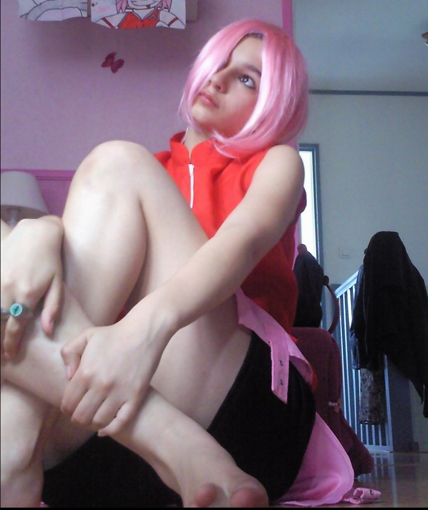 1girl cosplay female hair_over_one_eye legs long_hair naruto pink_hair sakura_haruno solo