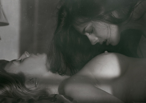 2girls arm breasts closed_eyes earrings female girl_on_top hair lesbian lips long_hair looking_at_another lying monochrome multiple_girls neck nipples on_back photo sideboob