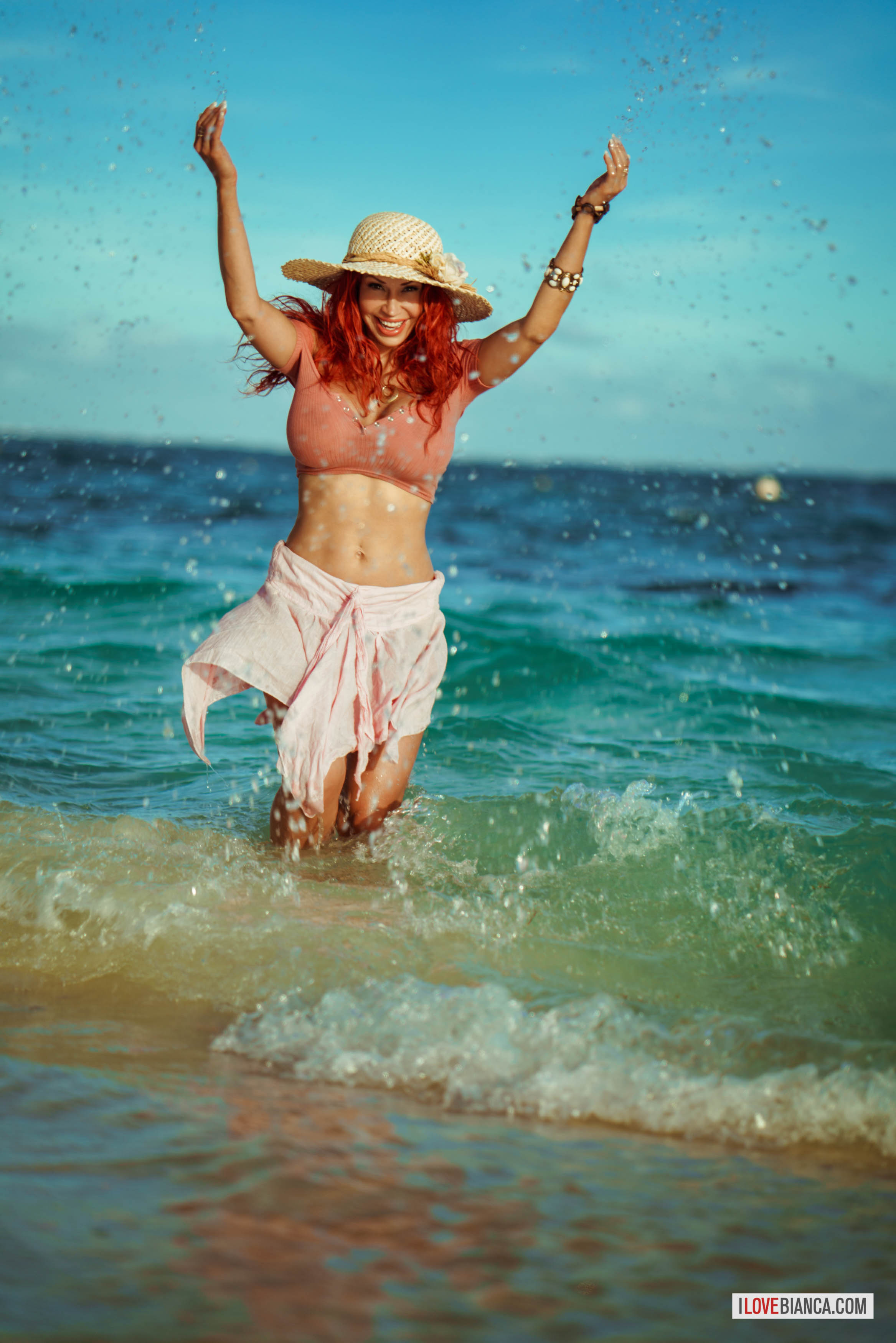 beach bianca_beauchamp breasts female hat large_breasts long_hair navel navel_piercing outside piercing red_hair solo water watermark