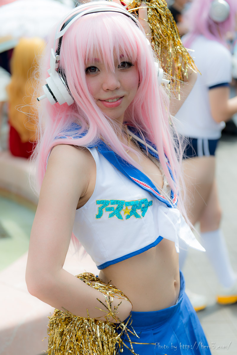 1girl asian breasts cheerleader cosplay female headphones long_hair midriff navel outside pink_hair solo super_sonico watermark