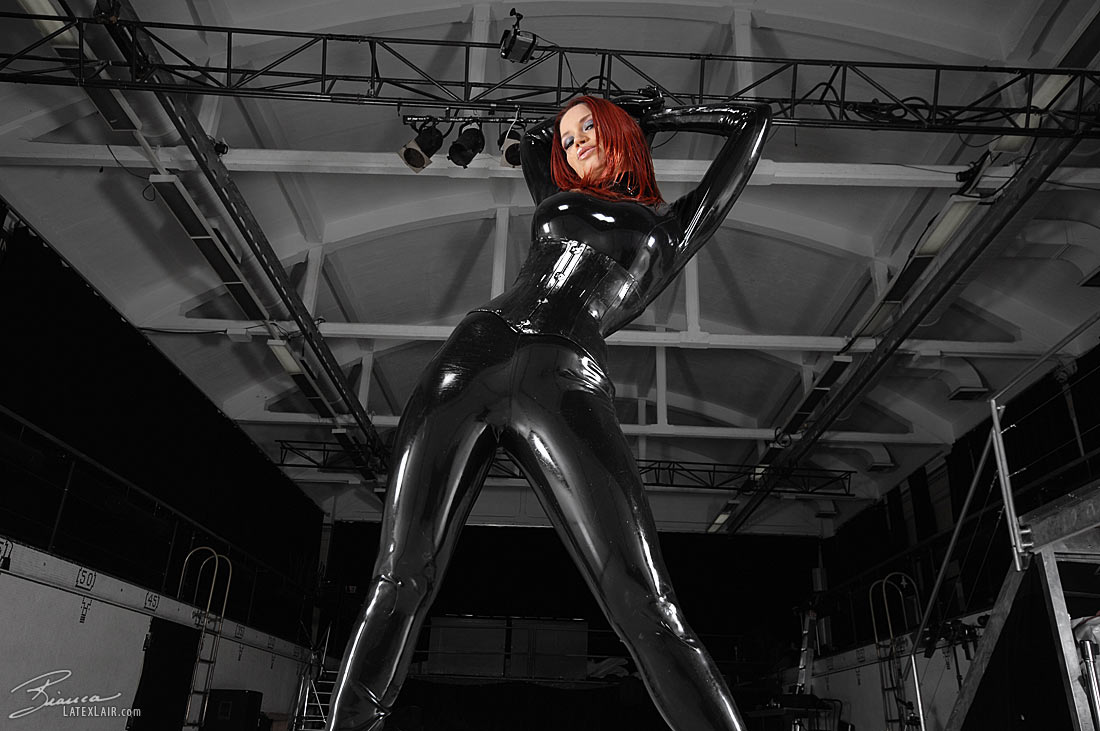 bianca_beauchamp breasts catsuit female gloves high_heels large_breasts latex long_hair red_hair shoes solo watermark