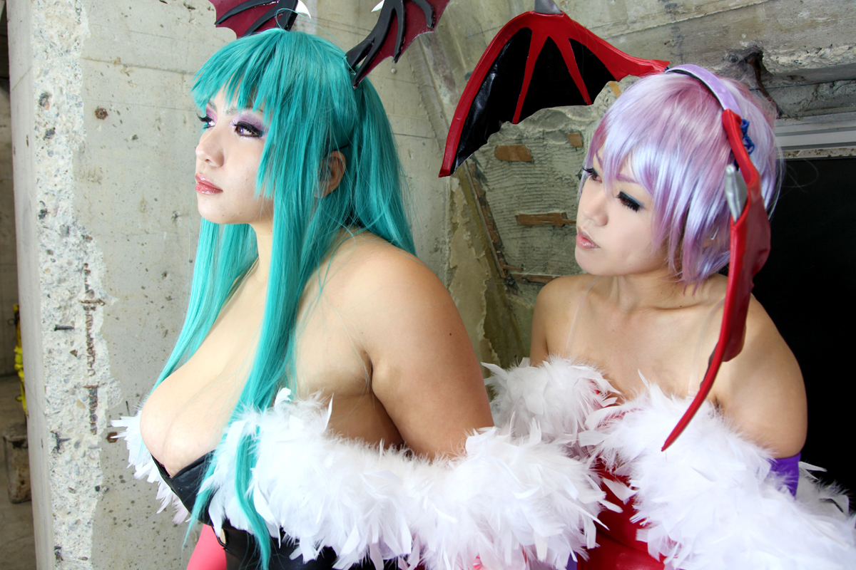 2girls aqua_hair bare_shoulders breasts capcom chouzuki_maryou cosplay darkstalkers female female_only huge_breasts lilith_aensland long_hair morrigan_aensland non-nude partially_clothed plump solo succubus suzuka_itsuki watermark wings