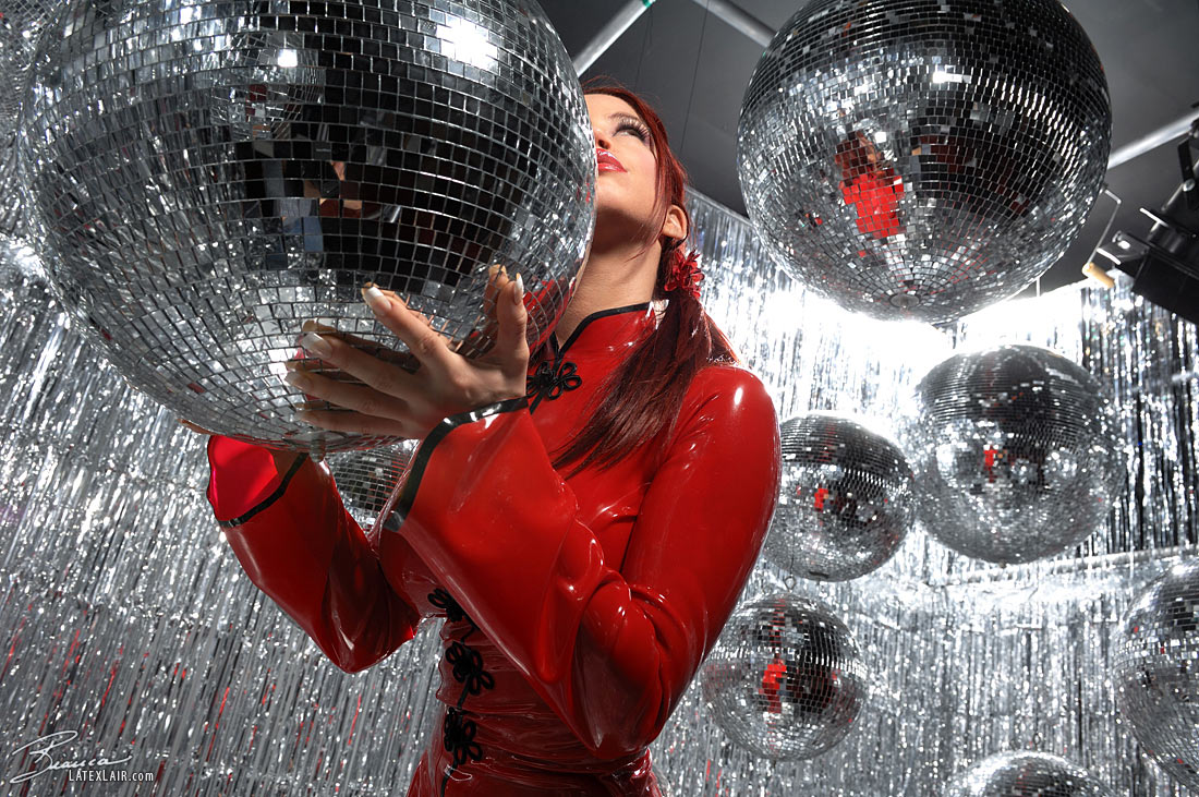 bianca_beauchamp breasts catsuit disco_ball female large_breasts latex long_hair pigtails red_hair solo