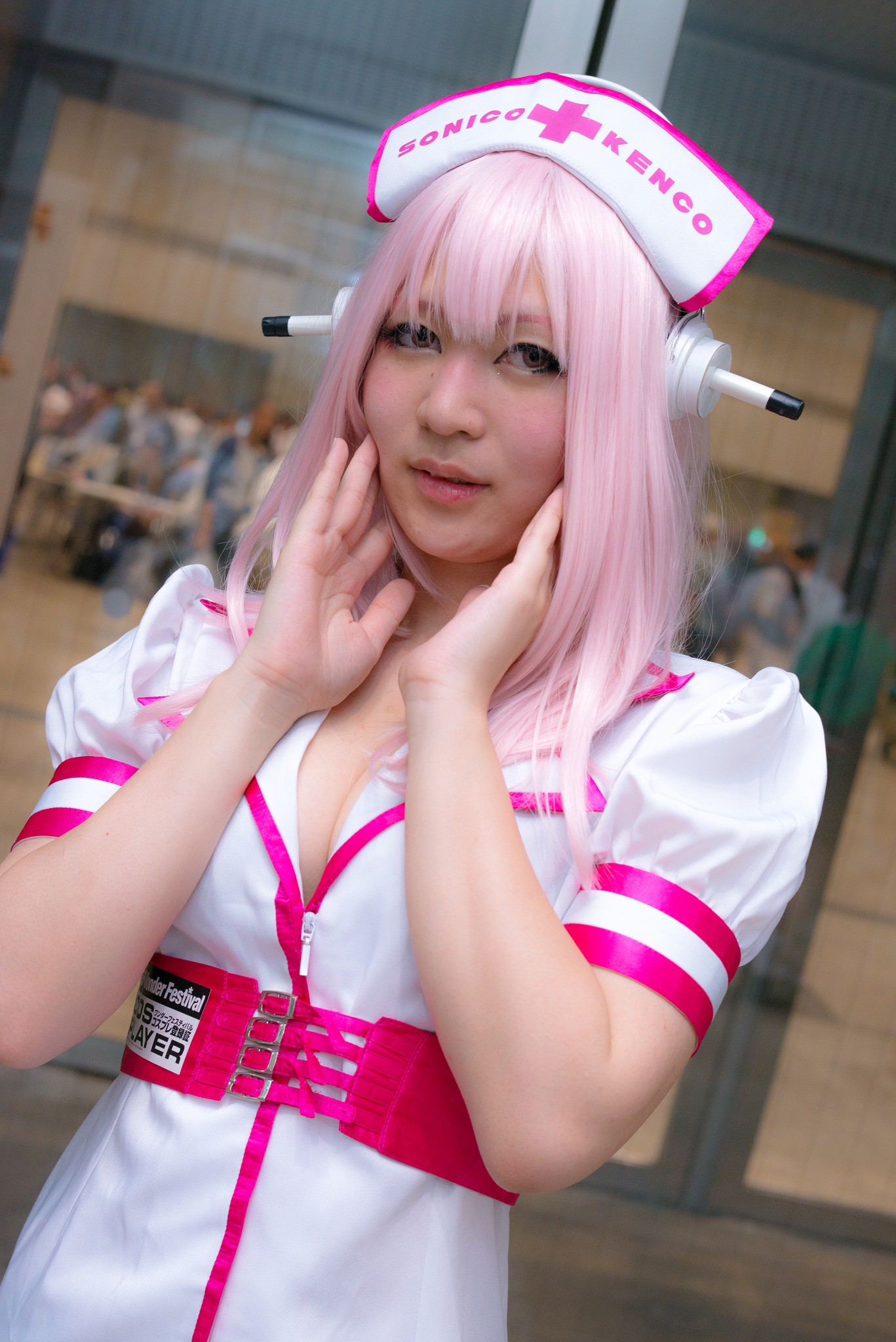 1girl asian breasts cleavage cosplay dress female headphones japanese long_hair nurse pink_hair solo super_sonico