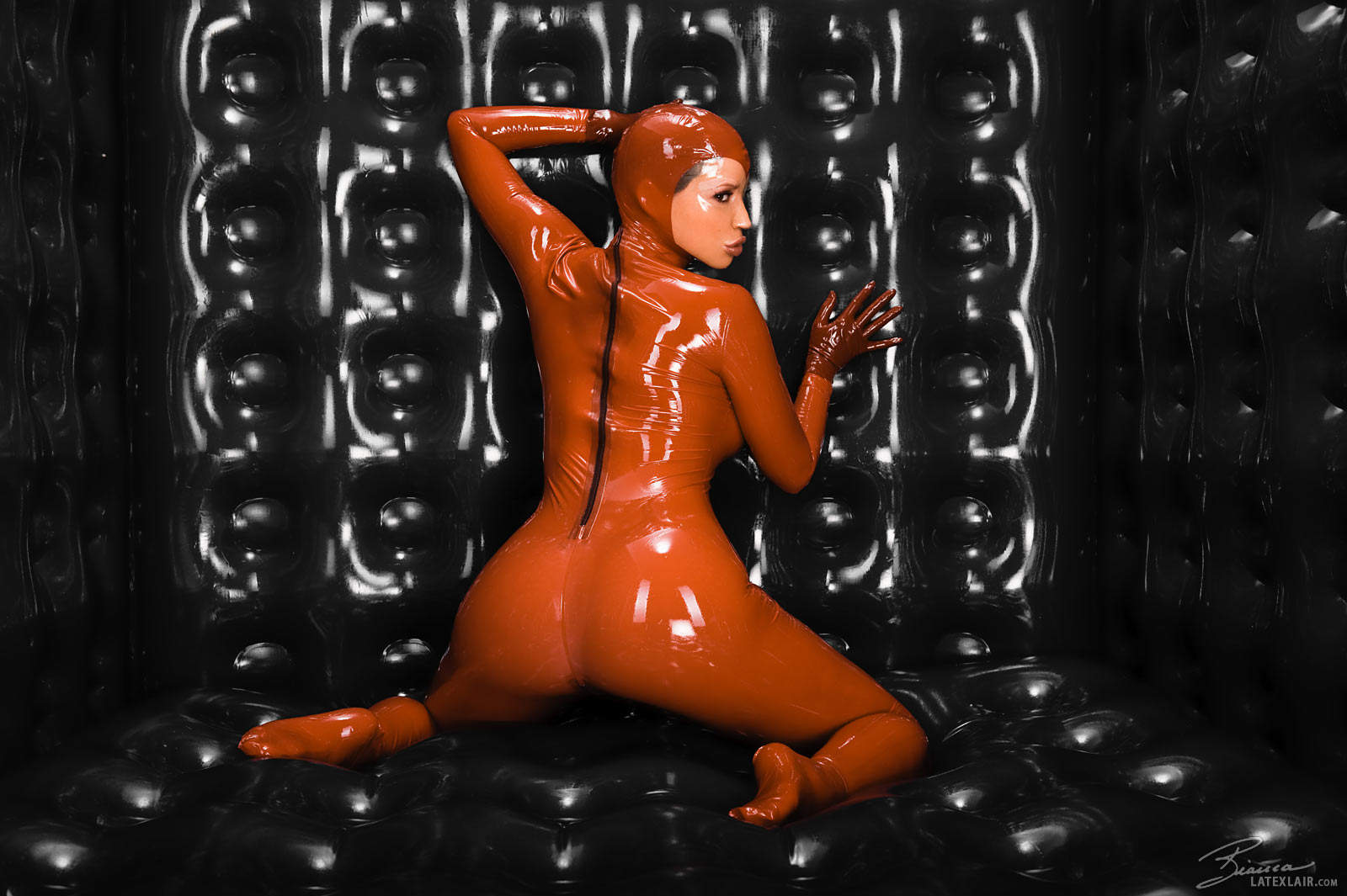 ass bianca_beauchamp breasts catsuit female gloves large_breasts latex long_hair looking_back red_hair solo watermark