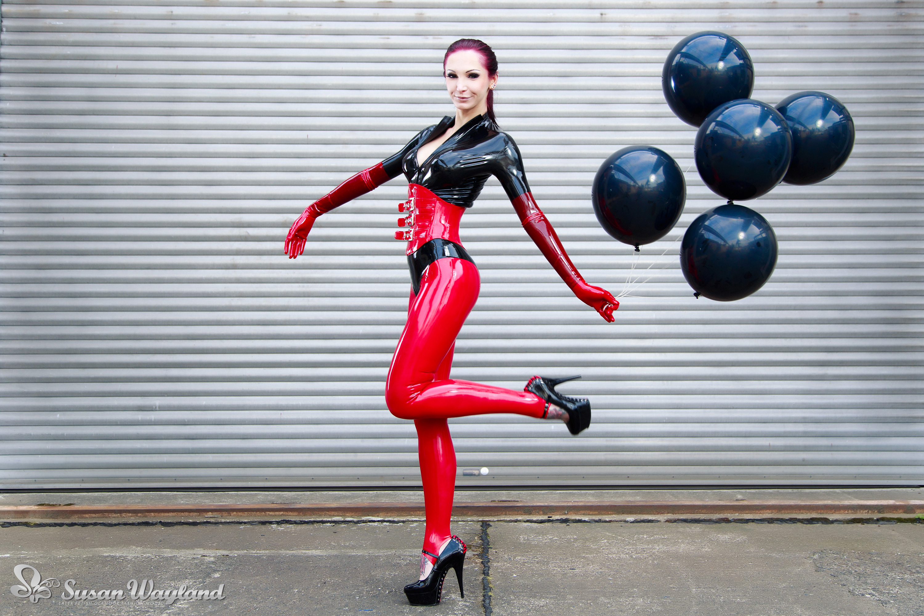 balloon black_hair breasts catsuit corset female gloves high_heels large_breasts latex long_hair shoes solo susan_wayland watermark