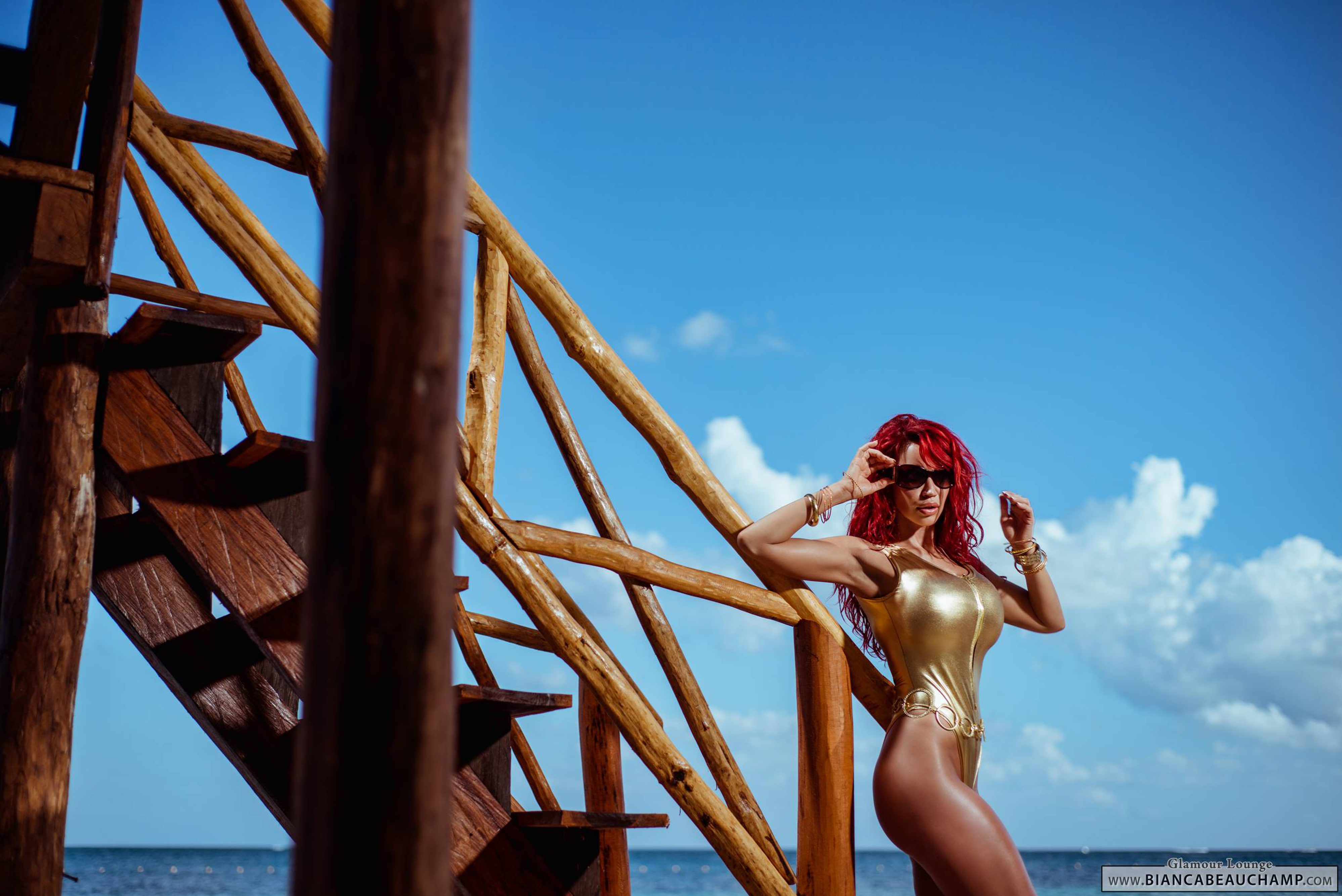beach bianca_beauchamp breasts female large_breasts long_hair red_hair solo sunglasses swimsuit water