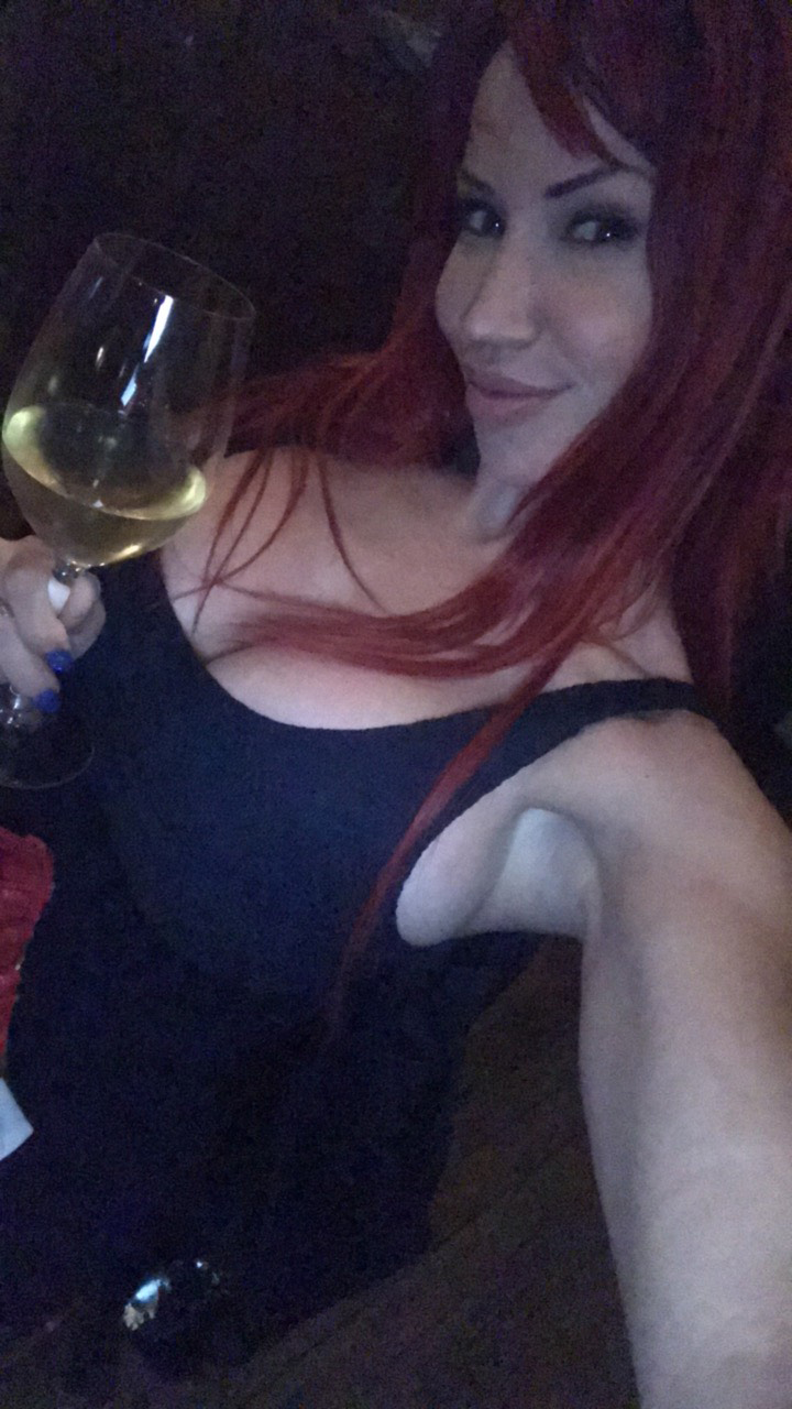 1girl alcohol armpits bianca_beauchamp breasts cleavage clothed female female_only large_breasts long_hair looking_at_viewer no_bra non-nude red_hair sideboob smile solo tan_skin watermark wine