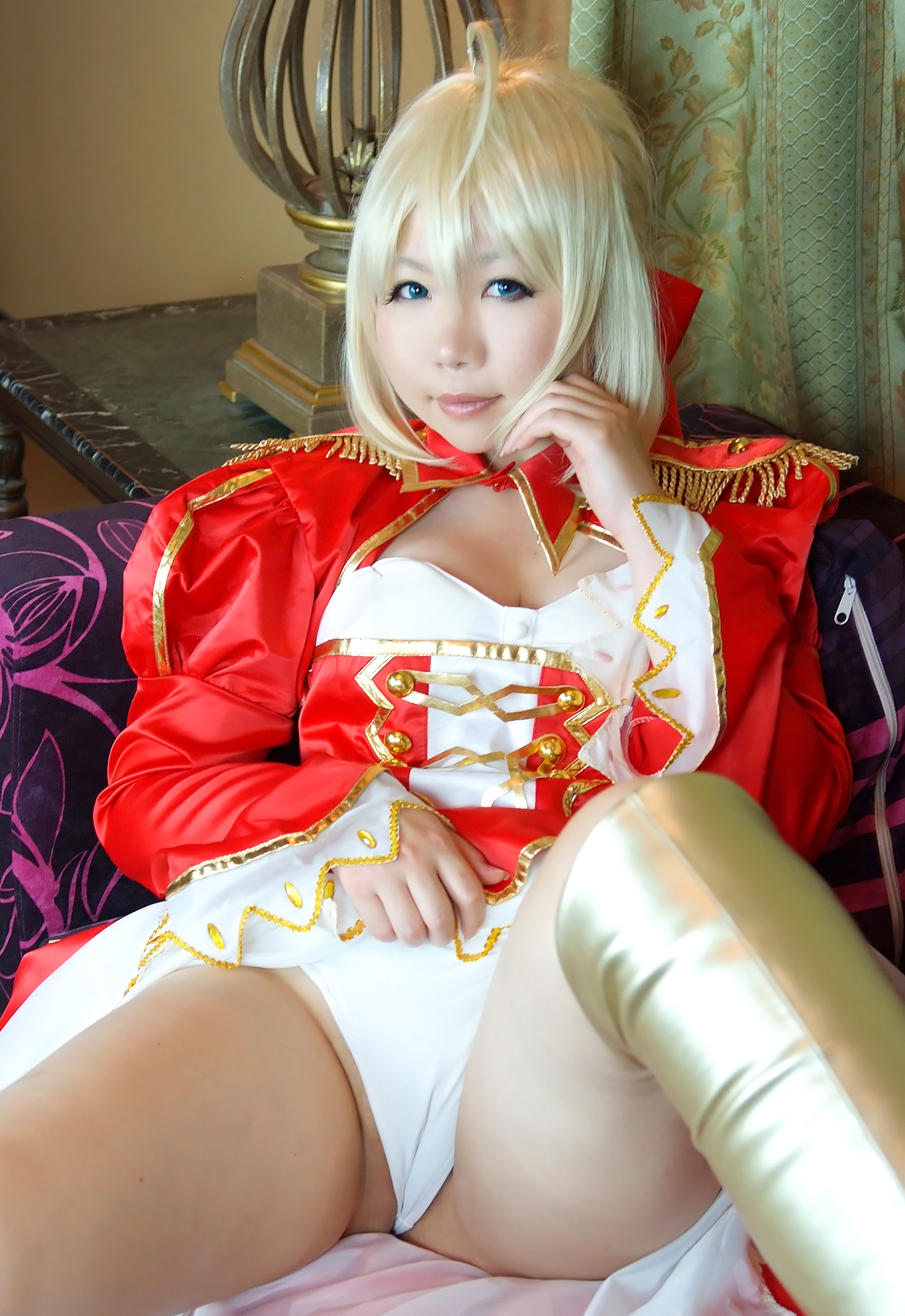 asian blonde_hair boots breasts cleavage cosplay dress female high_heels long_hair sitting sofa solo stairs sword