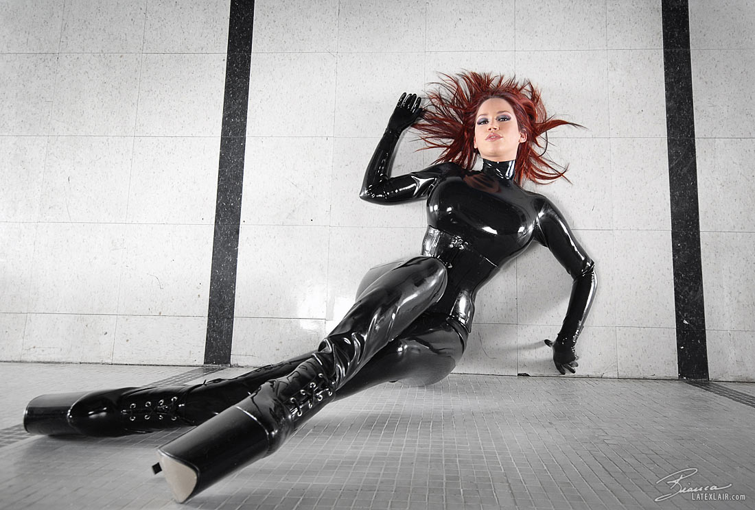 bianca_beauchamp breasts catsuit female gloves high_heels large_breasts latex long_hair red_hair shoes solo watermark